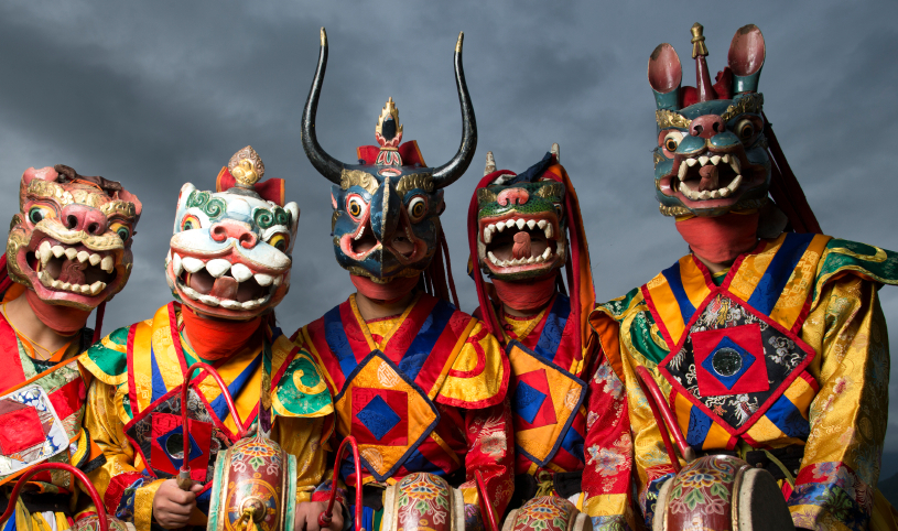 Thimpu, Bhutan - October 2nd, 2012 : group of dancers in traditional Bhutanese clothing and masks at the Dechenphodrang Lhakhang monestary - Bhutan has many festivals where monks and professional dancers perform age old rituals
