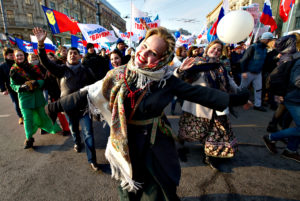 People of pro-government groups, with Russian flags, dance marching through downtown Moscow to mark People s Unity Day, a public holiday, in Russia, on Tuesday, Nov. 4, 2014. (AP Photo/ Ivan Sekretarev)
